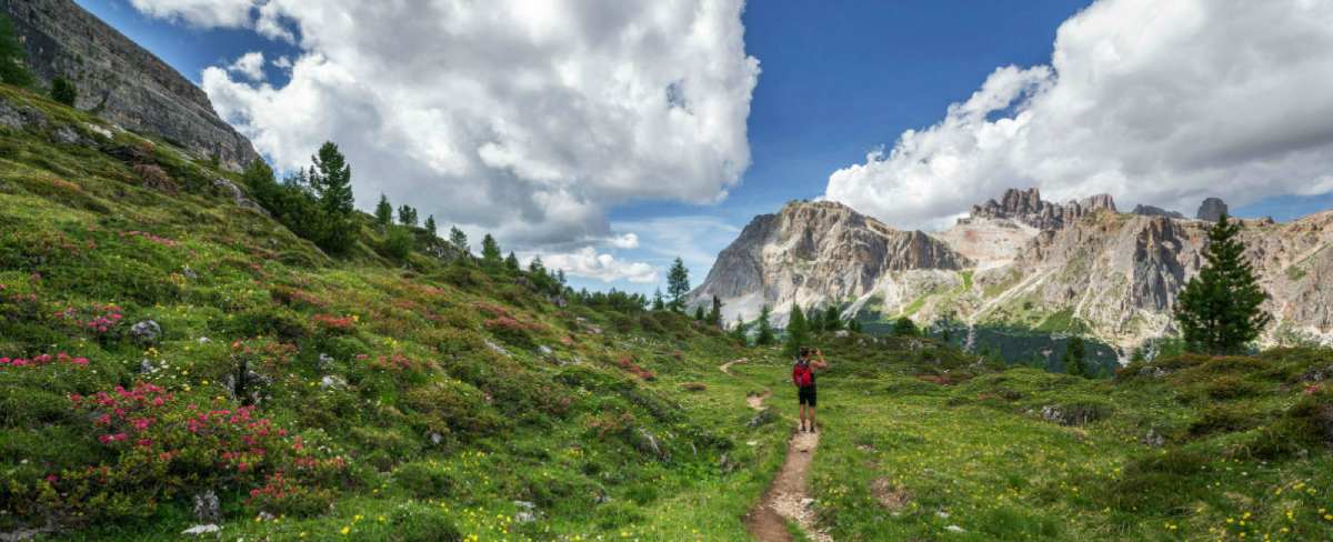 A backpacker, hiker, makes their way up a trail through the Rocky Mountains in Colorado